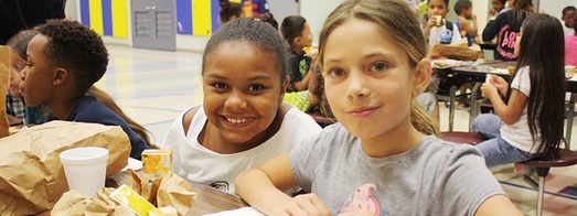 Children eating meals in school cafeteria